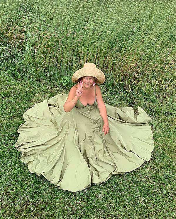 mulher com vestido longo sentada na grama
