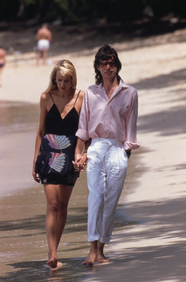 Mick Jagger and Jerry Hall on a beach in Mustique, 18th February 1987