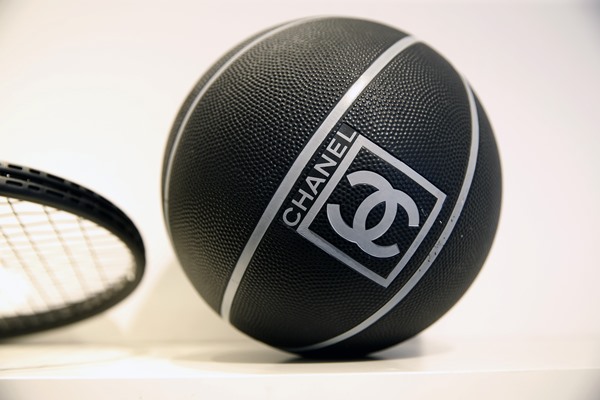 Bola de basquete preta da Chanel. Suas linhas são brancas e o logo da marca também - Metrópoles