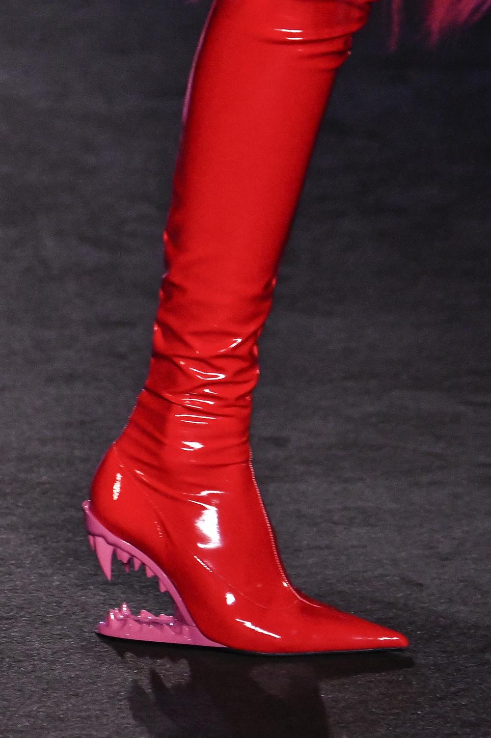 Desfile da marca GCDS na Semana de Moda de Paris. Na foto é possível ver a bota vermelha da marca, em tecido vinil, com um salto alto rosa que imita a mordida de monstro. - Metrópoles