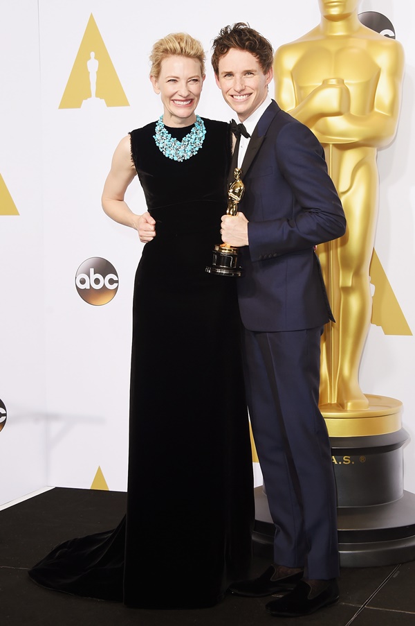 Cate Blanchett ao lado de redmayne usa vestido longo preto de veludo com colar grande da joalheria Tiffany. A peça traz pedras no azul turquesa característico da marca - Metrópoles 