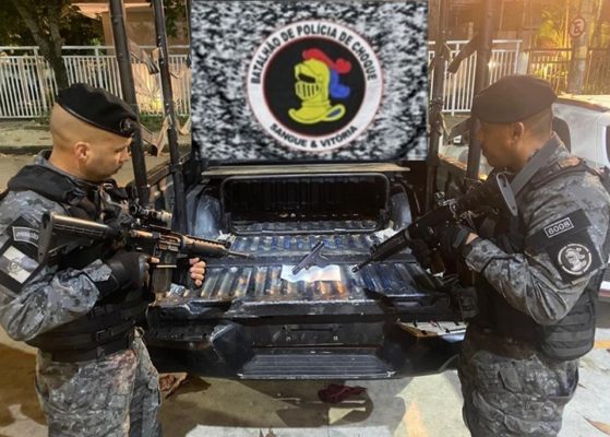Imagem colorida de PMs e pistola apreendida durante operação na Cidade de Deus (RJ) que deixou adolescente morto - Metrópoles