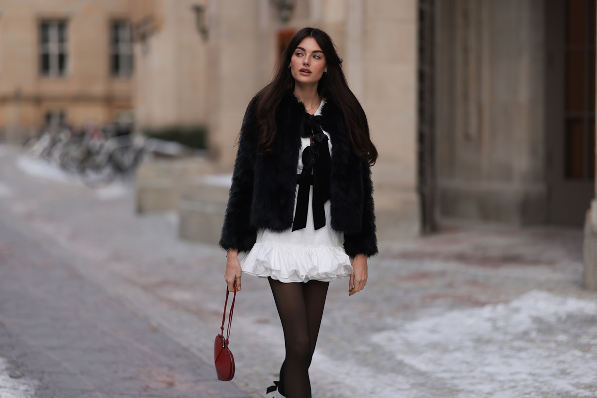 casaco preto vestido branco laços pretos bolsa vermelha de coração - metrópoles