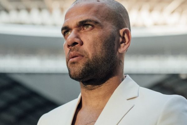 Daniel Alves posa, sério, de blazer branco - Metrópoles